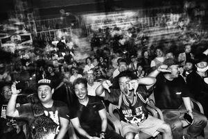 Fans heckle and laugh while enjoying a South Korean wrestling event in Seoul.