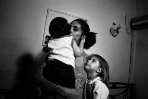 Maria 28 years old with her two children living in a small room given by the government.Athens, Greece Enri Canaj