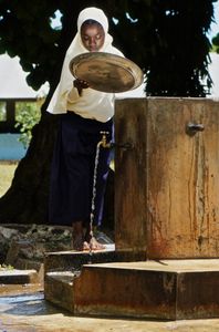 ZSP junior school student washing a communal lunch plate