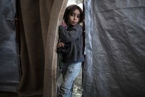 A Kurdish boy from Kobane stands inside a factory used as a refugee camp known as Suphi Nejat Agirnasli in the town of Suruc, Sanliurfa province, Turkey on November 9, 2014.