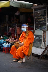 A mendicant monk with a shield and a mask on