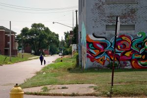 © Nicholas Gregory.     A mom walks home with her daughter. More than 75% of Detroit households with children include only one parent living in the home.