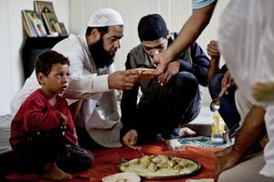 Supper in the container home of one of Zaatari's imams. © Tom Verbruggen