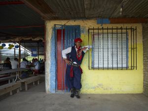 Gauchito Gil devotee and chamamè dancer spontaneously posing for his portrait in the temple of El Campito de la Carolina