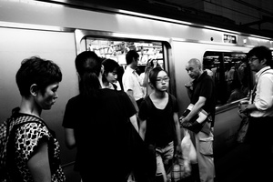 People get in and get ou of a train in Shinjuku JR station