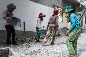 A team of female workers clear rubble from a construction site in central Phnom Penh.