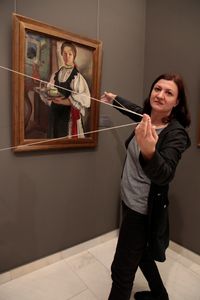 Artist and educator Liliana Mercioiu in front of the painting by Lucia Demetriade Bălăcescu, © National Museum of Art, Bucharest