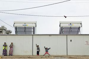 Two women and two young boys strike a pose in the refugee camp of Qushtapa, near Erbil. Around 7,000 refugees, mostly Syrian have been living there since 2012. © Tom Verbruggen