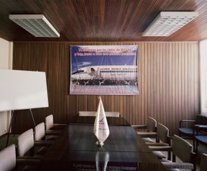 #01985 - In 1988 Pope John Paul II was a passenger in an LAB aircraft that now carries his name. The posterin the boardroom reads: “We carried you through the skies of Boliviaand today, with God, you are our protector. With your help we will continue to make history”.