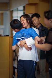 Feng receives daily physical therapy sessions and, despite suffering from cerebral palsy and autism, has been able to stay at home with his parents, who provide around-the-clock support and attention.