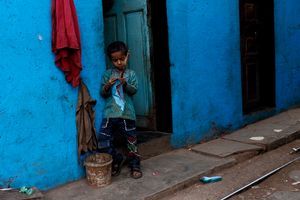 A boy and a blue wall