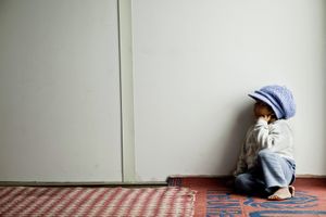A young boy waiting for supper in his container home. © Tom Verbruggen