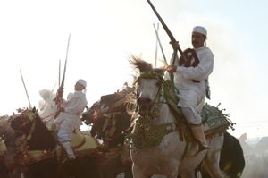Riders pull to halt in the smoke . Oulad Haddou, Bouskoura, Morocco