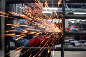 A prisoner at Coldingley makes prison gates in the steel workshop. HMP Coldingley, Surrey was built in 1969 and is a Category C training prison. Coldingley is focused on the resettlement of prisoners and all prisoners must work a full working week within the prison. Its capacity is 390 prisoners.