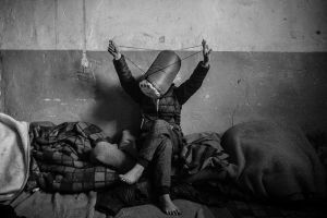 A young boy inside the barracks