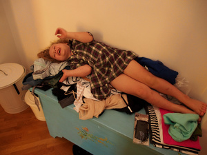 Margot playing with the mass of my clothes while I try to put some order