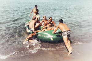 Some boys on their rubber boat, on the beach of Casamicciola, a few days after the earthquake, shouting, laughing and continuously singing "il pompiere paura non ne ha" (the firefighter has no fear).