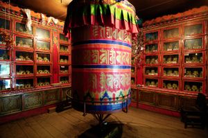 Draksum-Tso Lake is about 41km off the highway between Lhasa and Bayi, Tibet. It's a beautiful alpine lake surrounded by 6000 meter mountain peaks. There's  a magical little monastery on an island in the lake one can reach by way of a floating bridge. This huge prayer wheel is in a side chapel. Photographed on 3 July 2005. © Forest McMullin
