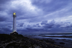 Seascape with storm / The Slangkop lighthouse is the tallest lighthouse on steel tower in South Africa. It is located on the Atlantic Ocean, close to the southern tip of the Cape Peninsula, the Cape of Good Hope. A place of gale force winds and sudden storms throughout the year.