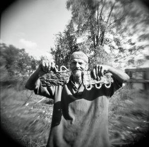 A metal scrapper who makes a living digging on the grounds of an abandoned scrap yard shows off old radiator parts he unearthed and will sell for cash.
