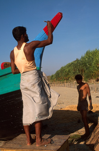 Man painting Fishing boat, St Martin Island, Bangladesh