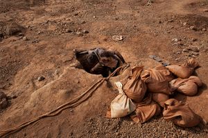 The mines, as deep as 50 meters, are dug by hand by men, women and children.There are always ropes for the buckets of ore but not always for the boys who scrabble up and down the pits finding footholds and hand holds in the dirt walls. Losing grip here could be fatal. © Matjaz Krivic