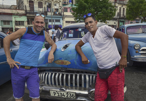 The owners stand in front of their 1952 Buick in central Havana.