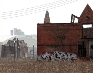 Ford Field, seen in the background, sits on a portion of Paradise Valley. Within a block of Detroit's surging Mid-Town area, skeletons of neighborhoods exist. In some areas, pockets of new development border scattered abandoned buildings and empty lots in bizarre fashion. © Nicholas Gregory