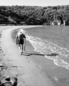 Old man walking at San Montano Bay, Lacco Ameno