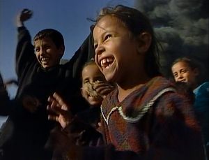 Baghdad, Iraq  (2003).  Irresistible joy.Children, against the burning streets of Sadr City, few days after the crowded Shia neighbourhood of Baghdad changed its name. It used to be called Saddam City.