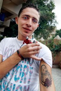 A boy showing a tatto of Christ                          The Coptic World© Bert Spiertz