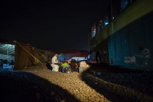 Young Syrian men are guarding the belongings of their family who are waiting to board the coach. With their border ordeal over and their status as refugees registered with UNHCR they will face a host of challenges in their new life in Jordan. © David Brunetti