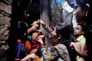 A child is vaccinated in Antop Hill slums in Mumbai, Maharashtra