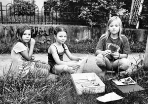 Youngsters in a Dayton neighborhood sell doll clothes on the street to help out with the family finances.