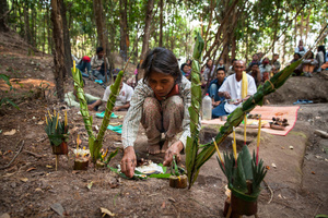 An elderly woman assists during an offering to the spirits prior excavation by the ADF team in Phnom Kulen. Siem Reap Province, Cambodia.