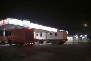 One of the trucks which is carrying conex -a kind of portable houses- in the gassed station and these temporary habitation are the most important thing victims of earthquake requested