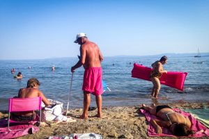 Tourists in Greece, on the coast of the Aegean Sea on the island of Evia, August 2017