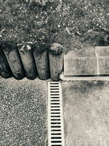 Asphalt, wooden Posts, Grass and Gutter