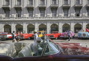 Vintage American cars parked across Parque central in central Havana.