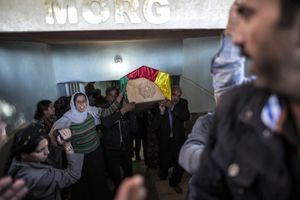 Kurdish people carry the coffin of a Kurdish Women's Protection Unit (YPJ) fighter who died during fighting in the besieged Syrian border town of Kobane, during a funeral in the town of Suruc, Sanliurfa province, Turkey on November 7, 2014.