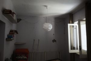 Amalia shows the damages in her house.