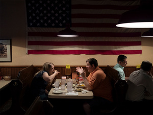 USA. Somewhere on the highway. 2015. Couple eating .