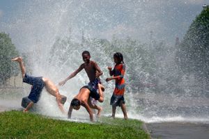 With temperatures soaring, these children from Detroit's East side cool off with the help of a fire hydrant. Sadly, scrappers have stripped the brass threads from many of the fire hydrants, rendering them useless even for recreation. © Nicholas Gregory