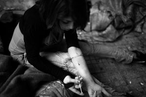 Joana 22 from Greece taking heroin in a corner of the street near the city center. She works as a sex worker during the evenings . Joana lives in a very cheap hotel alone. Athens , Greece Enri Canaj