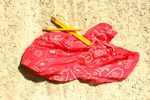 red bandana with three yellow hand sharpened pencils