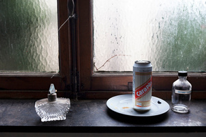 Still life with emty perfume bottle, cara pils on a plate and empty bottle of disinfectant