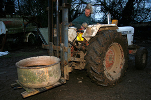 Moving the vat of apple juice with the help of a tractor