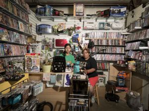 Carolina Mendoza works with her mother, Elsa Ramirez in their shop in the Pendergrass Flea Market in Pendergrass, GA. Carolina is a high school student and an artist who designs custom stencils for t-shirts and, when she's not in the shop, Elsa runs a web site called sewingmachines.com. © Forest McMullin