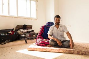Mohammed and Layan in their new home. Layan was reluctant to have picture taken, she didn't want to show her face but Mohammed said he wasn’t afraid and wanted the world to see how he now lives. They are struggling and behind on the rent. They don’t know how much longer they will be allowed to stay. Their flat is small and all they possess in the world fits into the suitcases. © David Brunetti