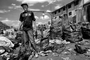 © Tony Corocher - Hard work - Just as you enter Mathare Slum you run into this "recycle factory". These people spend their days picking up plastic bottles from the streets and then try to sell them by weight. They hang around Mathare and try, like everyone else, to make a living out of whatever they can find.